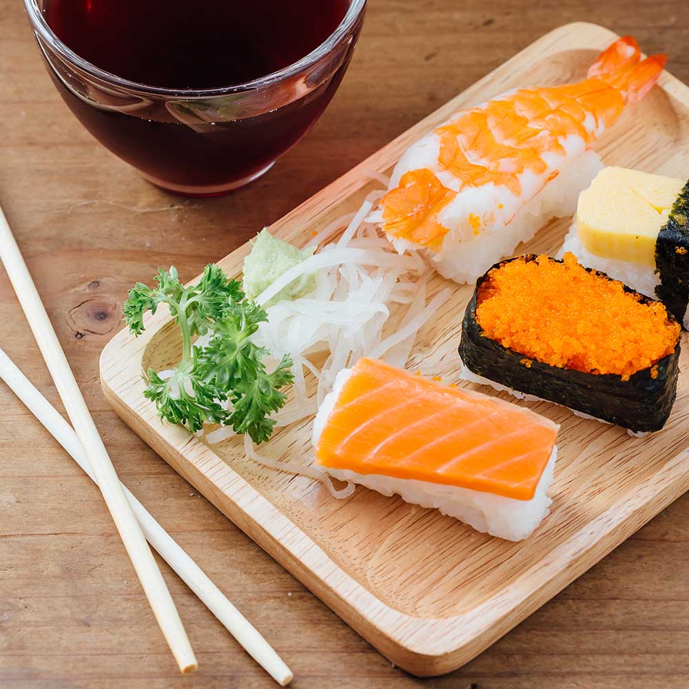sushi-set-on-wooden-table-with-healthy-water-PKMHZ2E